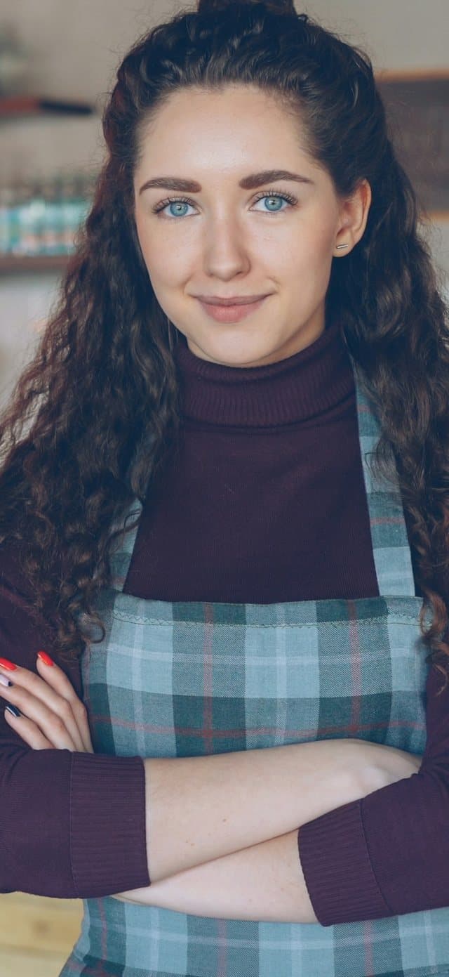 Megan, a café owner in Atlanta, smiling in her apron